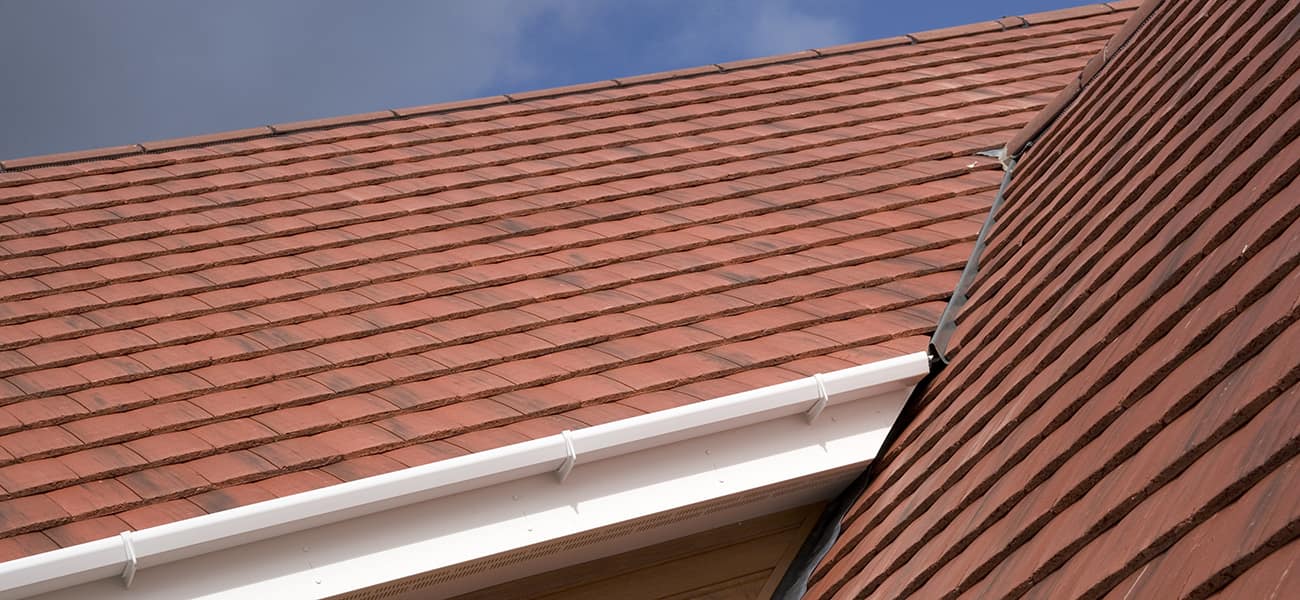 An image of Ashmore Interlocking double plain Tiles from Marley in situ on a pitched roof.