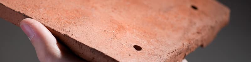 A close up image of a singular Burford Canterbury Handmade roof tile, available from Marley.