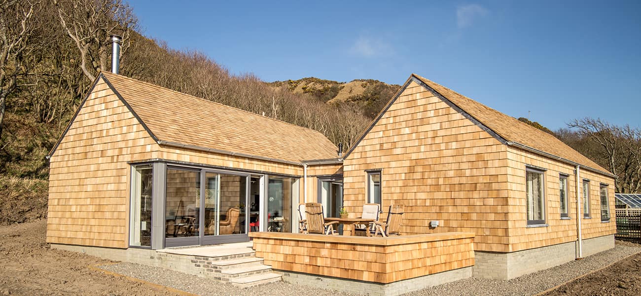 two house built entirely with timber shingles