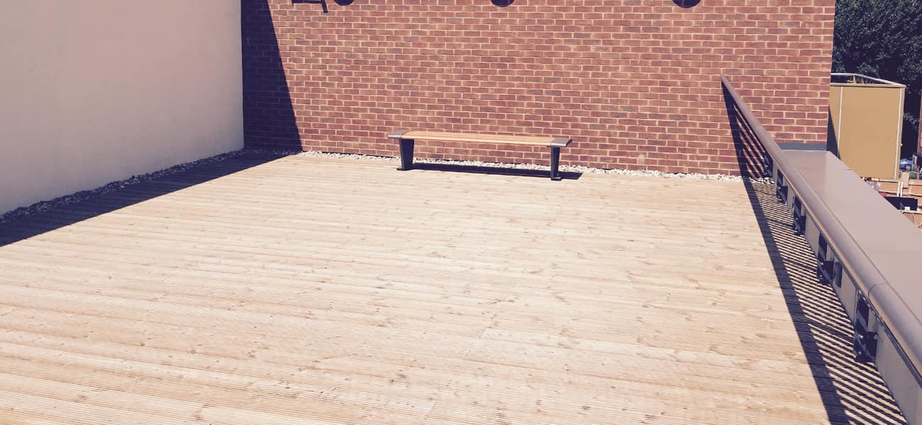Timber decking terrace with a bench at the back