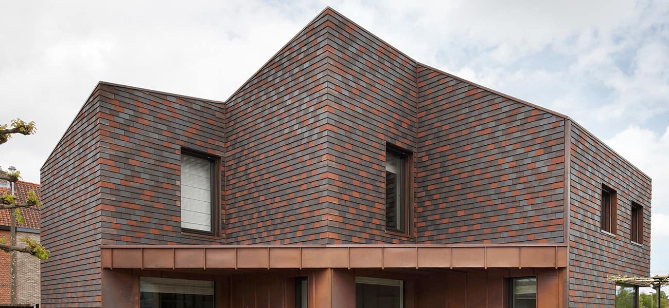 Panoramic view of Hawkins Single Camber Clay Plain Tiles from Marley to give character to the minimalist design. 