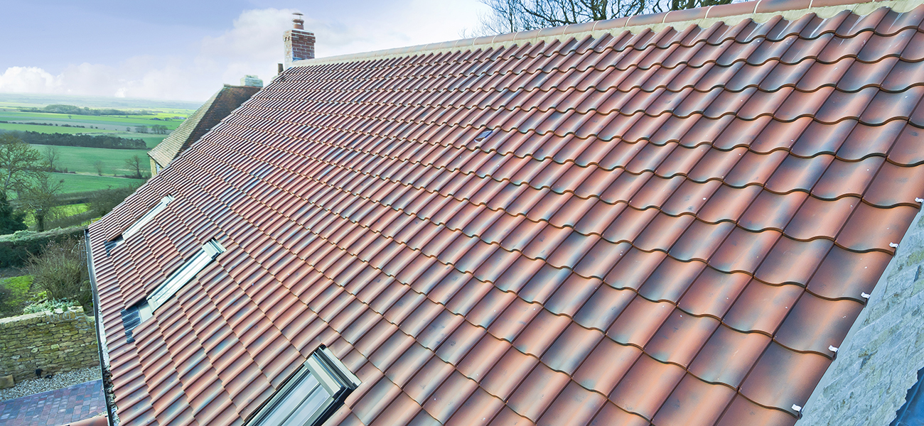 Lincoln clay interlocking tile in natural red showing ridge detail