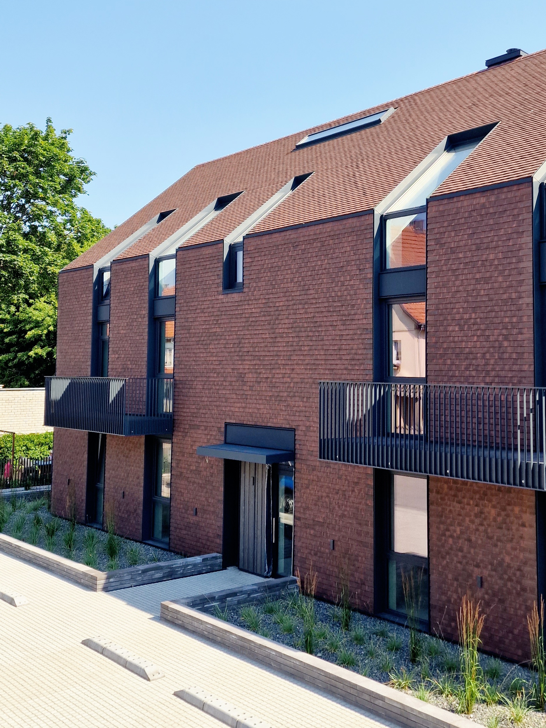 Marley acme double camber clay plain tiles installed on a large apartment building in Lithuania