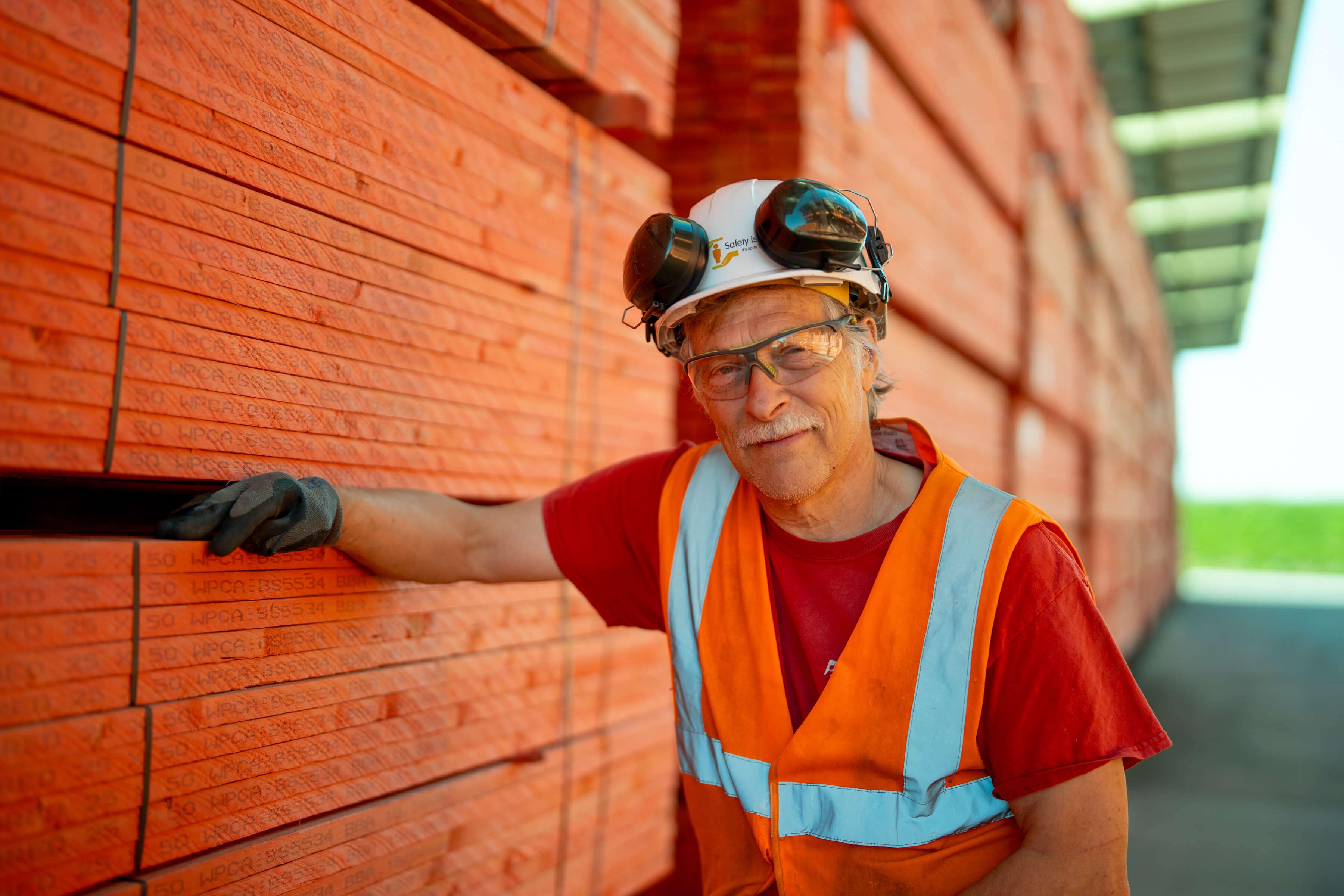Image showing a man nailing roof tiles on JB red batten
