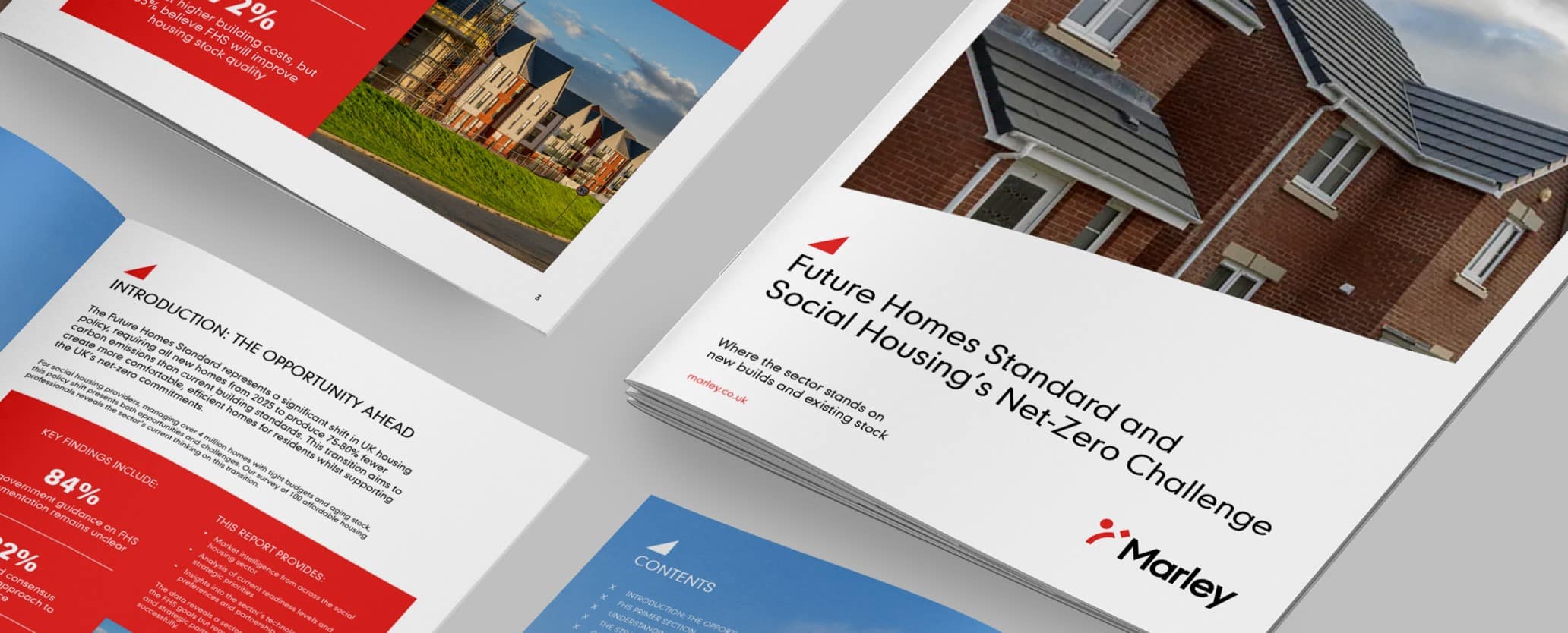 Image showcasing a number of copies of a whitepaper titled "Future Homes Standard and Social Housing’s Net-Zero Challenge"